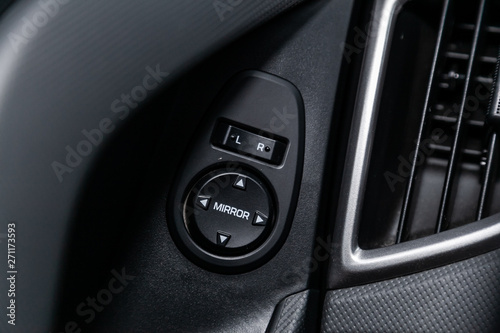 Interior design of the modern car: : side mirror adjustment buttons. luxury prestige car interior.