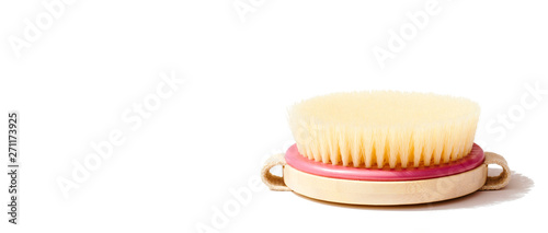 Dry body massage brush on white background at sunny day. Tool for smooth and soft skin. Place for text.