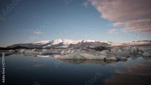Timelapse of Glacier Lagoon / Jökulsarlón at sunrise with icebergs and clouds in view