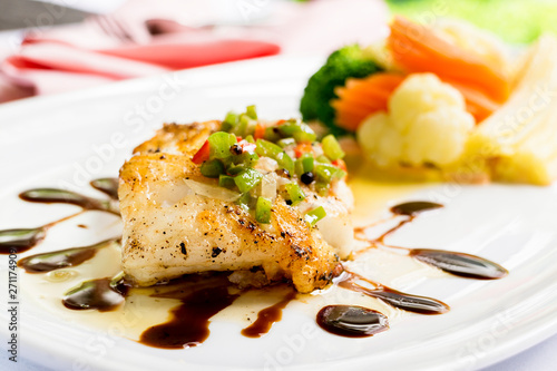 grilled snapper fish steak with vagetable : Healthy lunch grilled snapper fish fillet with fresh salad close-up on a white plate.