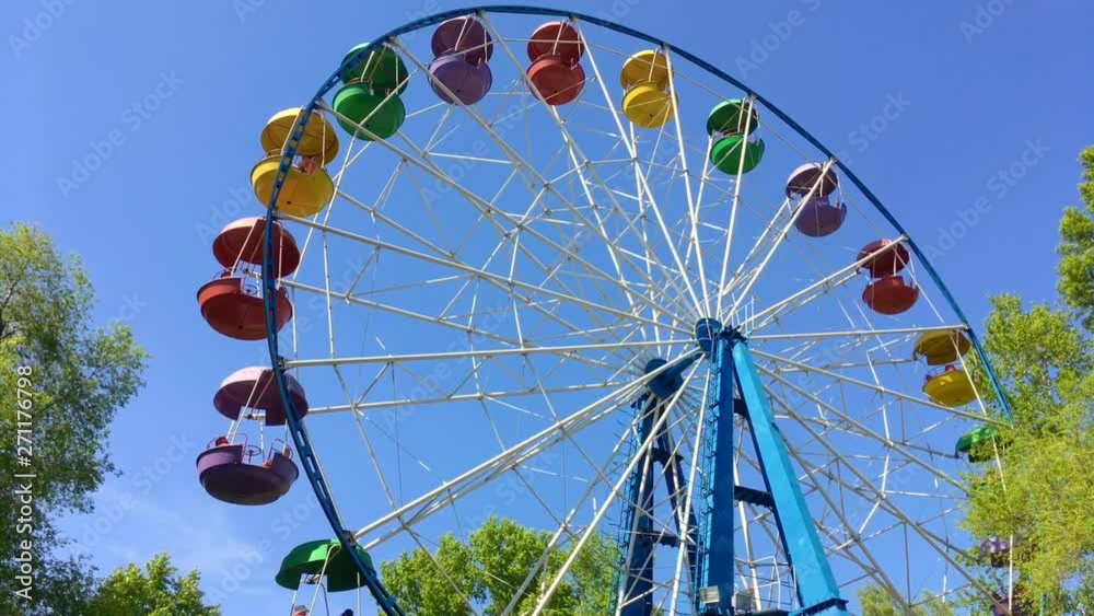 Moving ferris wheel on the blue sky background. Moving ferris wheel on the blue sky background.