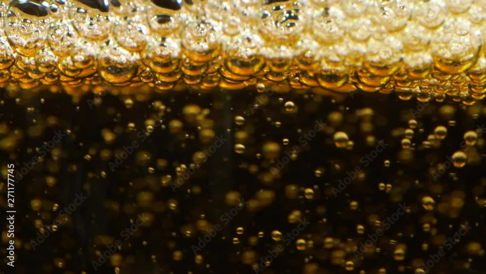 Slow Motion extreme Closeup Pouring Apple Cider limonade, black background.