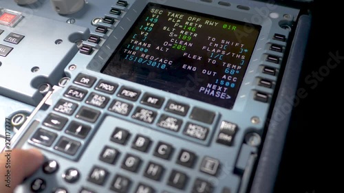 Hand of pilot input some flight parameters Airbus A319 A320 A321,preparing flight on ground. photo