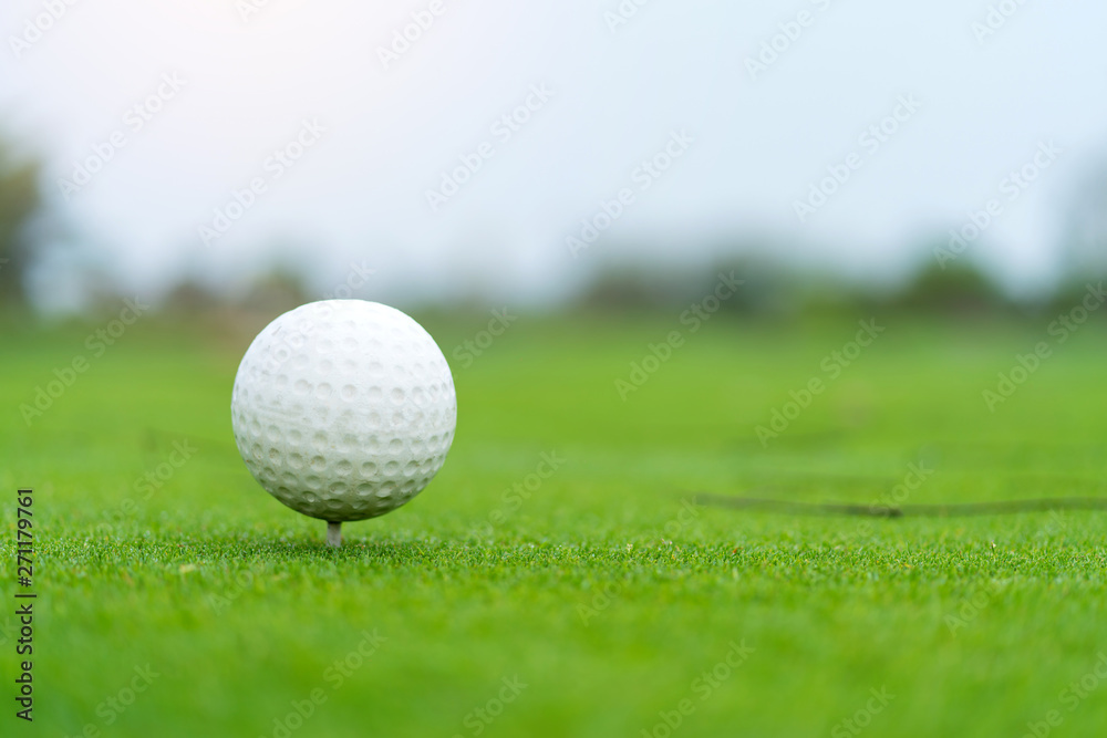 Golf ball on tee ready to be shot at golf court