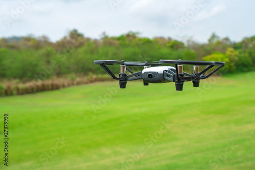 Flying drone above the green grass golf court