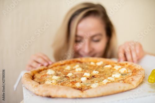 Portrait of a woman eating pizza. Beautiful young woman in black underwear eating pizza