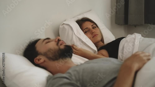 Couple with snoring problem concept, Woman has problem form her husband snoring while sleeping on bed photo