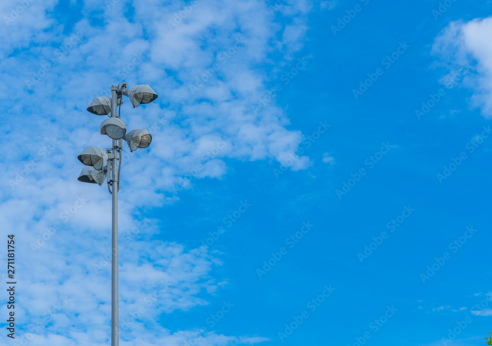 Spotlight on lighting tower Clound Blue sky background