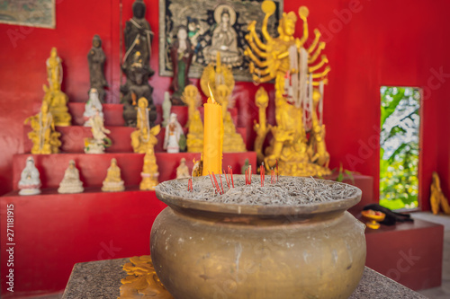 Burning praying with joss stick at Buddhist temple