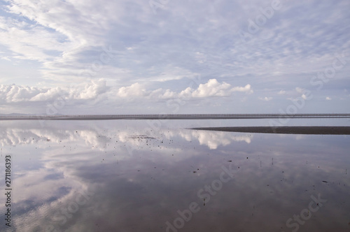 Low tide at sea with blue sky