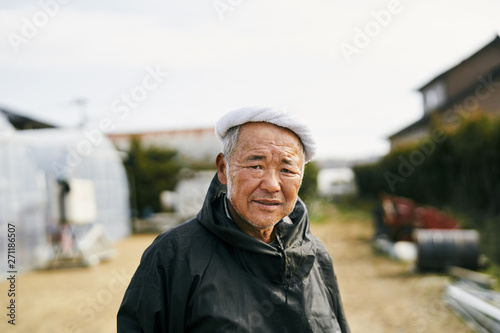 Portrait of senior farmer standing outdoors