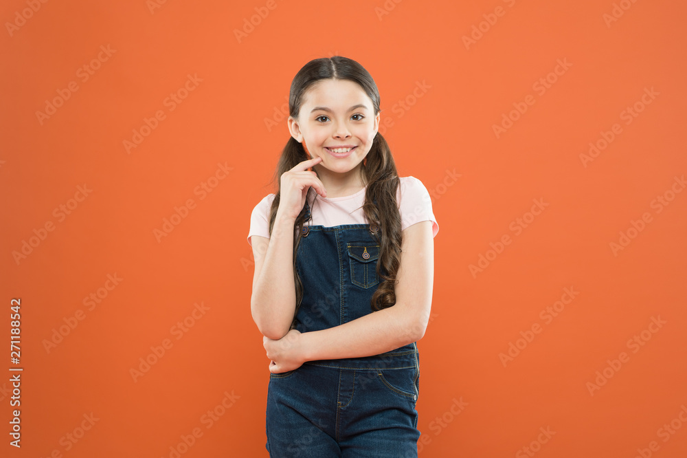 Grow mentally and physically healthy child. Wellbeing and health. Childhood concept. Fashion girl. Girl adorable kid stand over orange background. What is key to childhood happiness. Happy childhood Grow mentally and physically healthy child. Wellbeing and health. Childhood concept. Fashion girl. Girl adorable kid stand over orange background. What is key to childhood happiness. Happy childhood