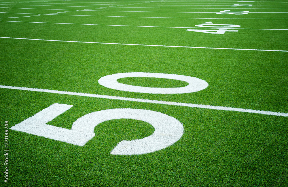 50 yard line on empty American football field. Closeup. 50 yard line on empty American football field. Closeup.