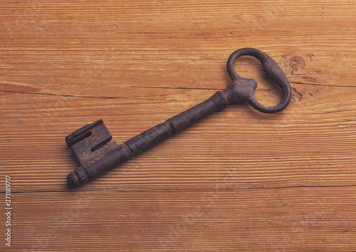 Old key on a wooden background