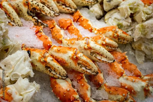 Several units of king crab claws over ice