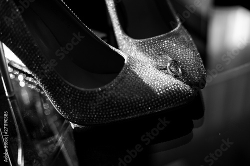 wedding rings on the bride's shoes. Wedding. Decor. Bride's shoes. Wedding bride's shoes and rings. Wedding white shoes © Denis