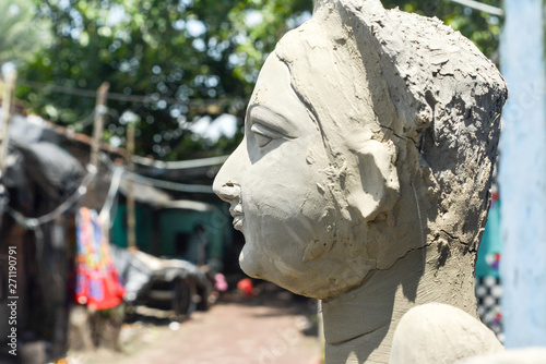 Close up Art model of Maa Durga pratima face. Goddess Durga sculpture made of clay during famous Durga Pooja Celebration. Taken from potter studio in Kumartuli, Calcutta Kolkata, West Bengal, India.