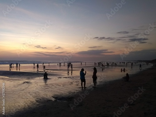 people on the beach at sunset in Bali, Indonesia 
