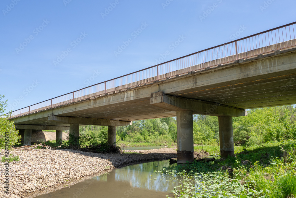 Reinforced concrete road bridge over the river. Close-up. Reinforced concrete road bridge over the river. Close-up.