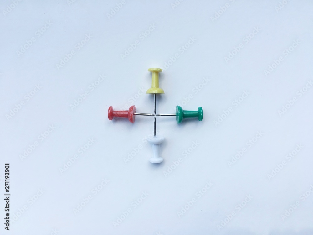 Colorful pushpins made cross isolate on white background