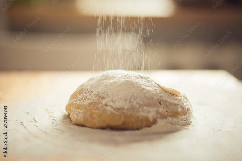 dough on a cutting board and pouring farina dough on a cutting board and pouring farina
