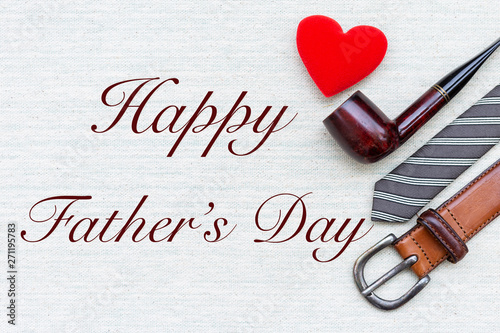 Happy Father' sday card idea, message on canvas fabric texture with leather belt and necktie with red heart and smoking pipe  photo