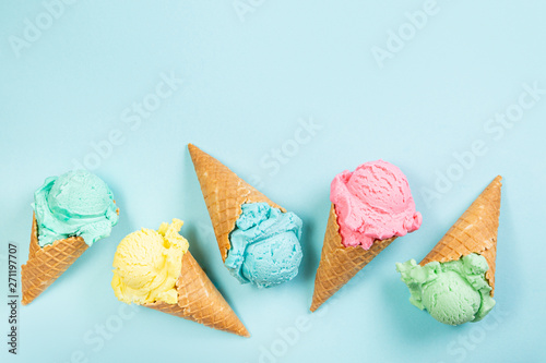 Tablou canvas Pastel ice cream in waffle cones, bright background, copy space