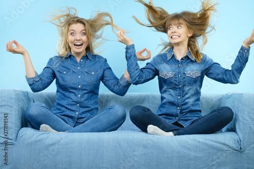 Tableau sur toile Two happy shocked women with windblown hair