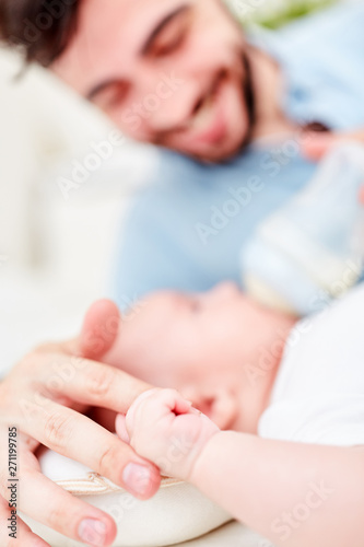 Liebevoller Vater hält die Hand von Baby
