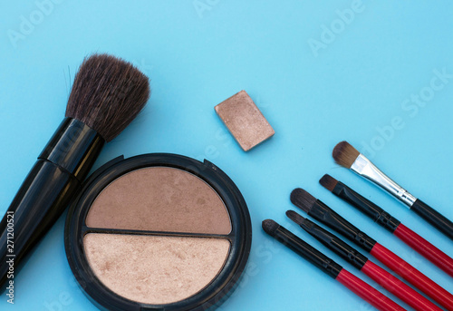make up brushes cosmetics blue background copy space