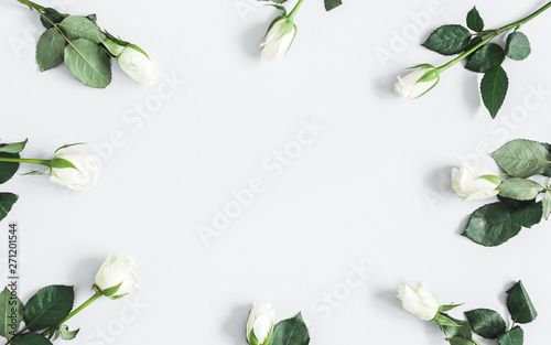 Flowers composition. White rose flowers on pastel gray background. Flat lay, top view, copy space