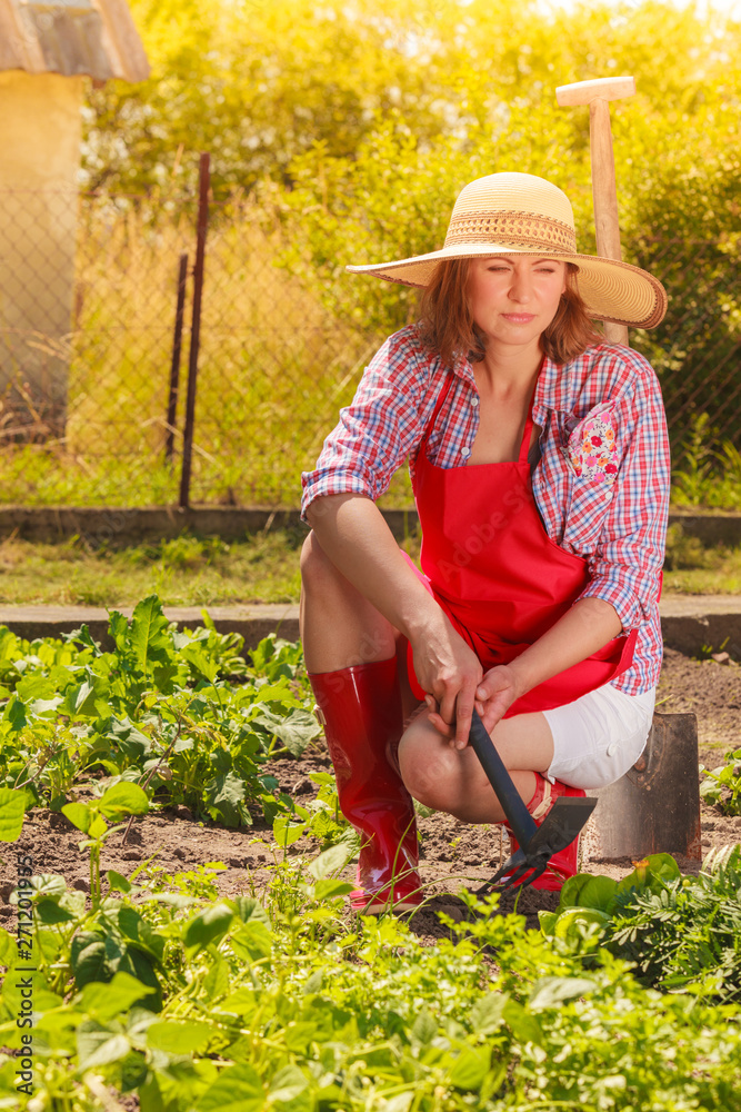 woman with gardening tool working in garden