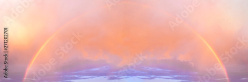 Billede på lærred Bright beautiful Full rainbow on the background of coloured cloudy sry while sunset