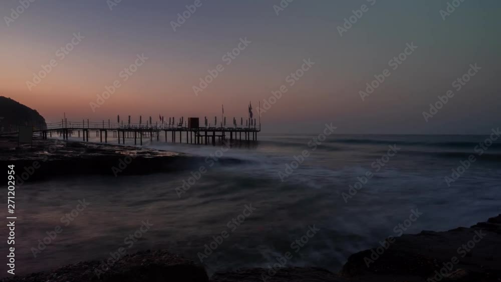 Beautiful sunrise over long jetty at the seascape.