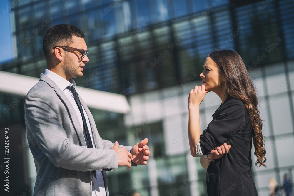 Business colleagues are talking outside the company building. Business colleagues are talking outside the company building.