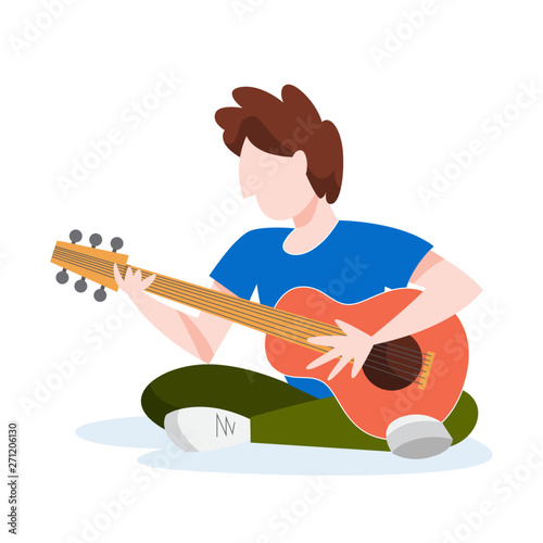 Boy sitting and playing acoustic guitar