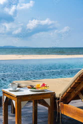 Vertical photo of delicious breakfast on the peaceful beach