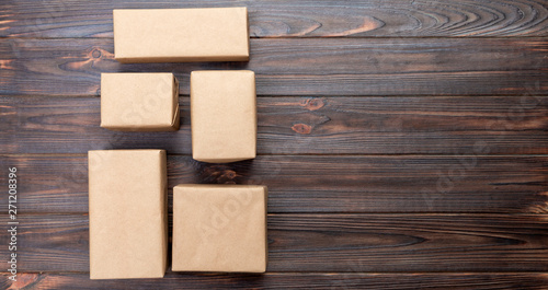 cardboard box on white wooden background, Brown mail package top view