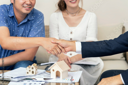 Obraz na płótnie Close up, Man shaking hands represent sale, Asian couple meeting financial adviser for home, real estate purchase, success business contract deals with sale
