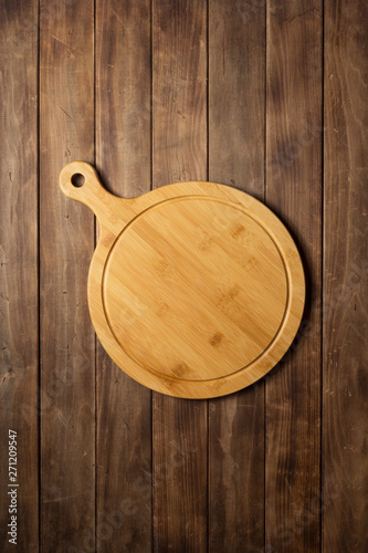 pizza cutting board at wooden plank board background