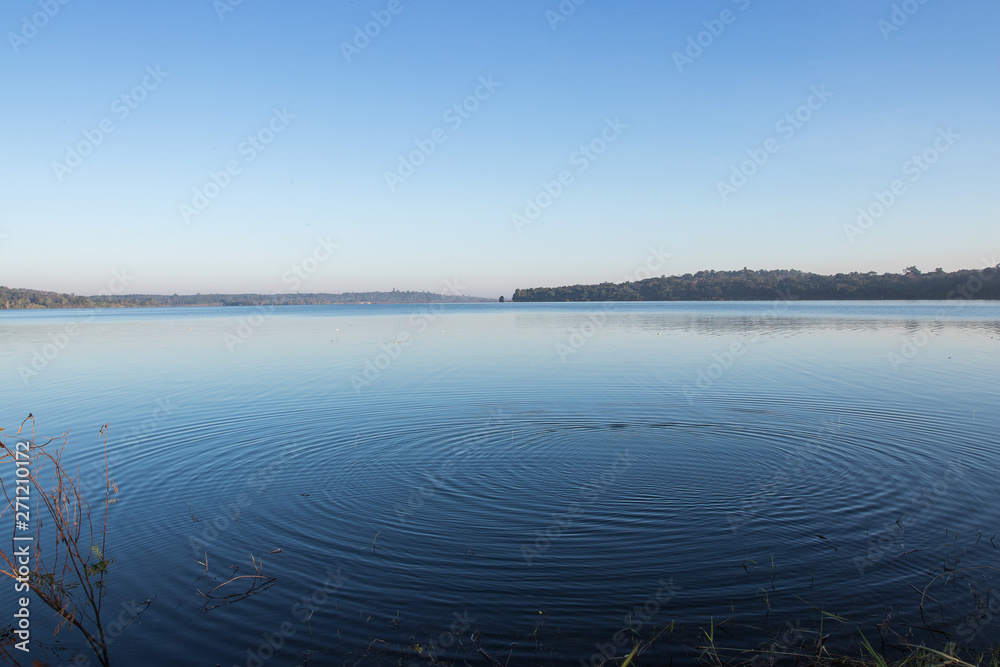 Circles on the blue lake with blue sky.