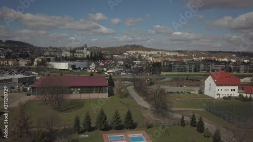 Gorlice, Poland - 4 5 2019: Panorama of the historic center of the European medieval city on the picturesque green hills. Trips to architectural monuments, temples, quarters and sports complex MOSiR photo