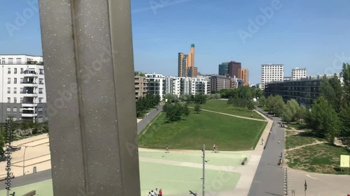 Berlin city skyline from elevated railroad bridge at park on sunny summer day