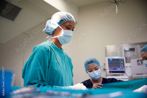 Female Surgical Team Working On Patient In Hospital Operating Theatre