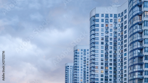 Real estate background. Ukrainian real estate market. Urban abstract background. Apartment building. Image of side view of big building with appartements at dusk. New apartments. Copy space