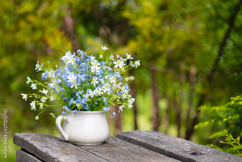 Bouquet of tender fresh flowers on the wooden table