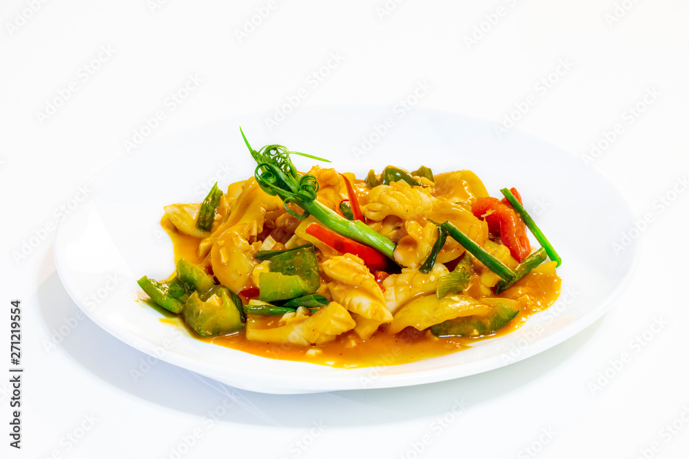 Stir-Fried Squid with Salted Egg Yolk on white dish isolated white background. Stir-Fried Squid with Salted Egg Yolk on white dish isolated white background.
