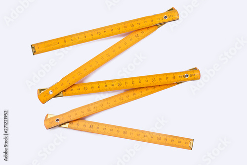Yellow wooden ruler isolated on white background. Wooden centimeter ruler. Carpenters tool.