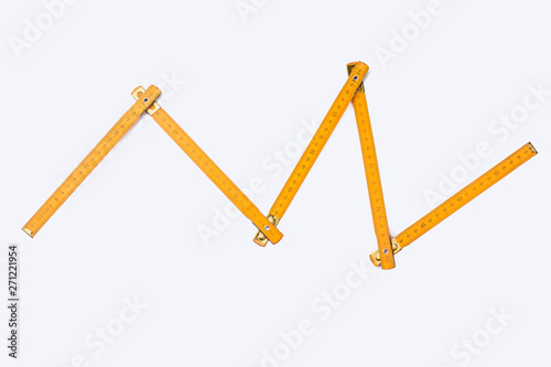 Folding ruler on white background. Image of yellow wooden yardstick. Carpenters tool with scale of numbers.