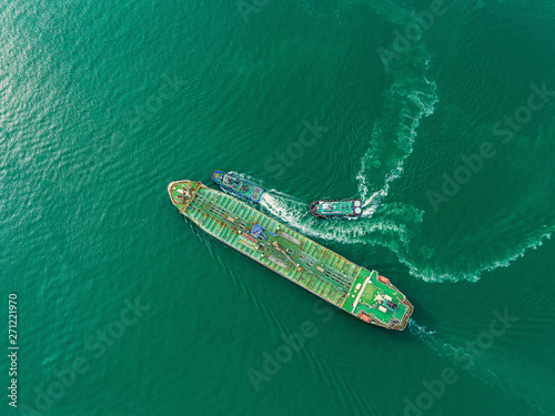 Aerial top view Oil ship tanker and tugboat for transportation oil from refinery on the sea. © Pawinee